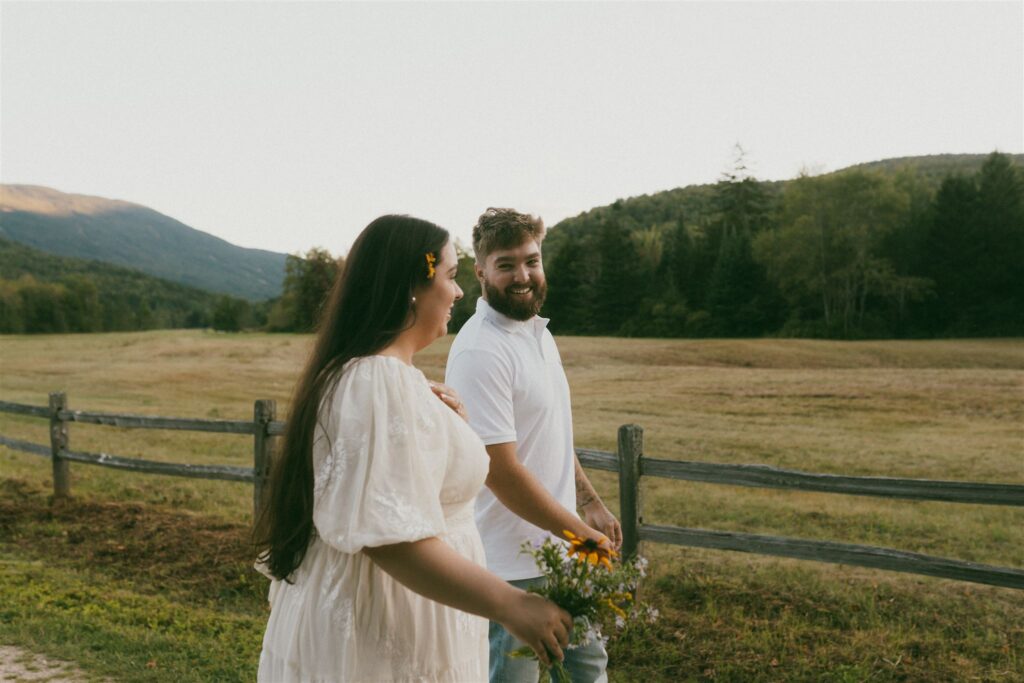 A couple enjoying flower picking in the White Mountains during their engagement. 