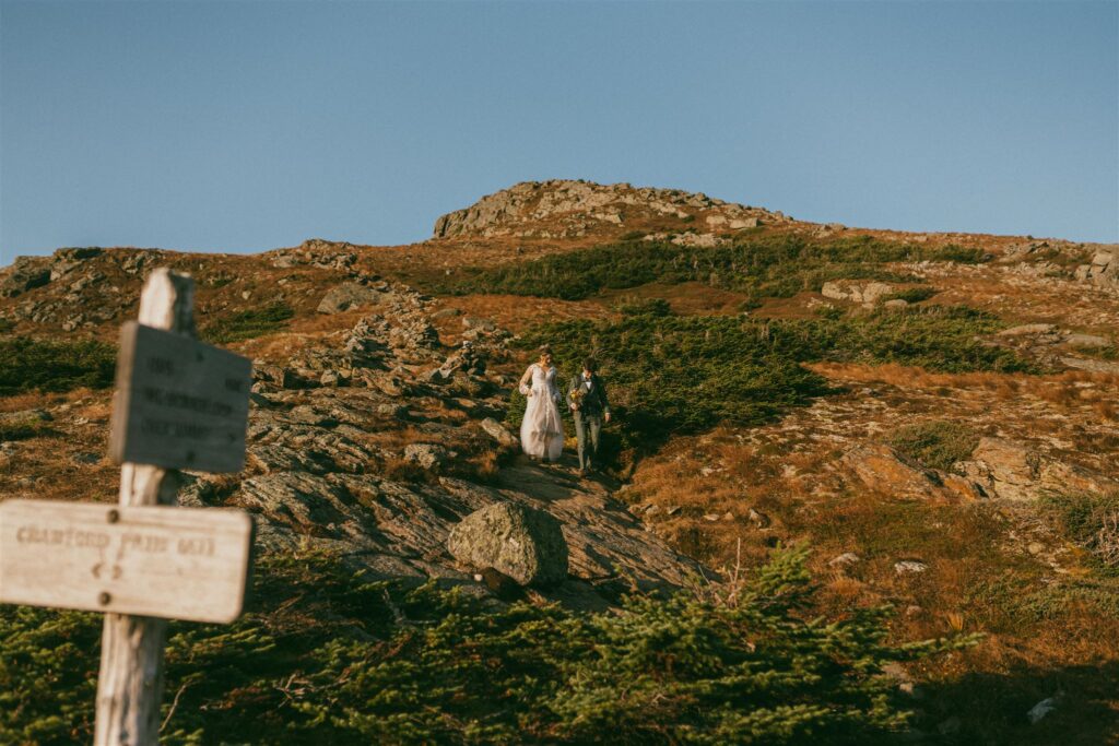 Couple hiking together during a White Mountains elopement