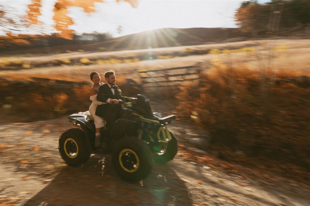 Couple riding an ATV together during their White Mountains elopement