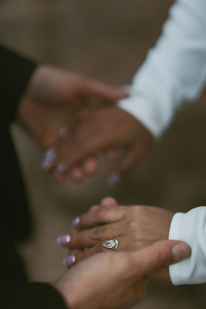 Close-up of a bride’s hands with an engagement ring during a fall elopement ceremony in the White Mountains of New Hampshire