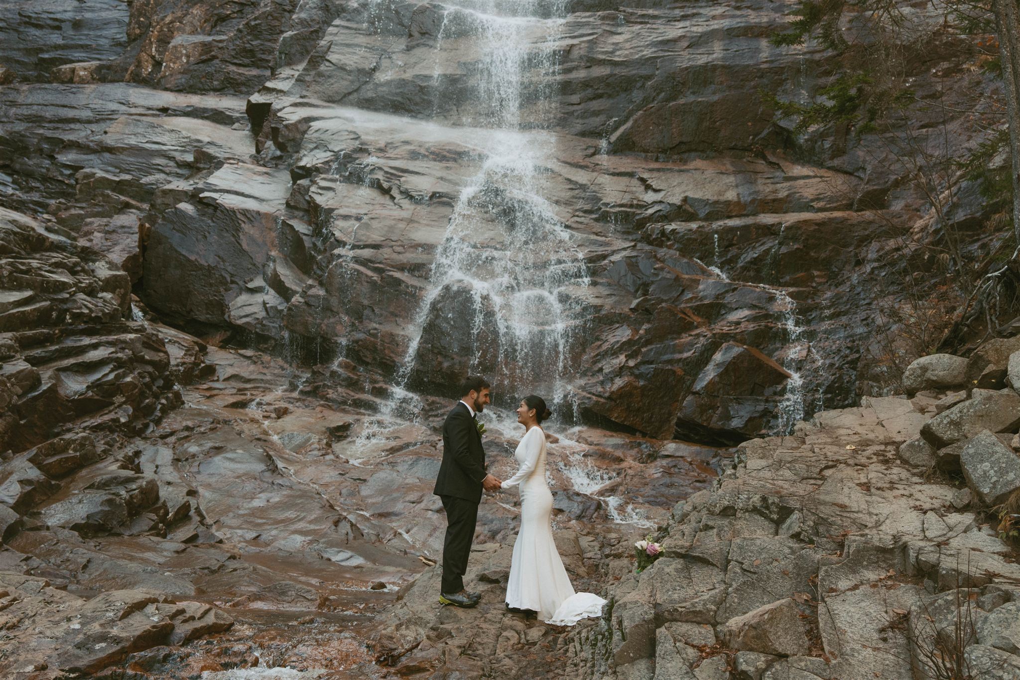 White Mountains fall elopement at Arethusa Falls with couple exchanging vows beside a waterfall