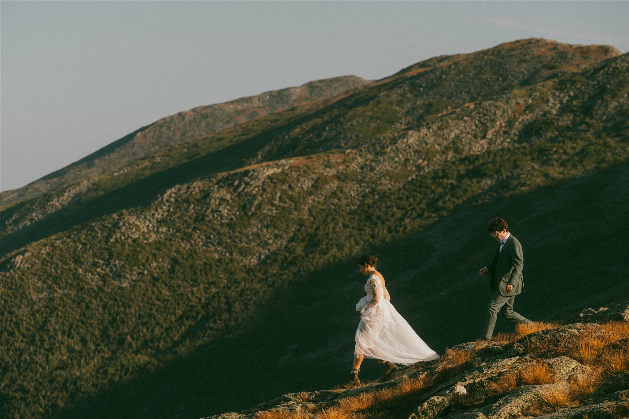 Couple hiking along a mountain ridge during a White Mountains elopement