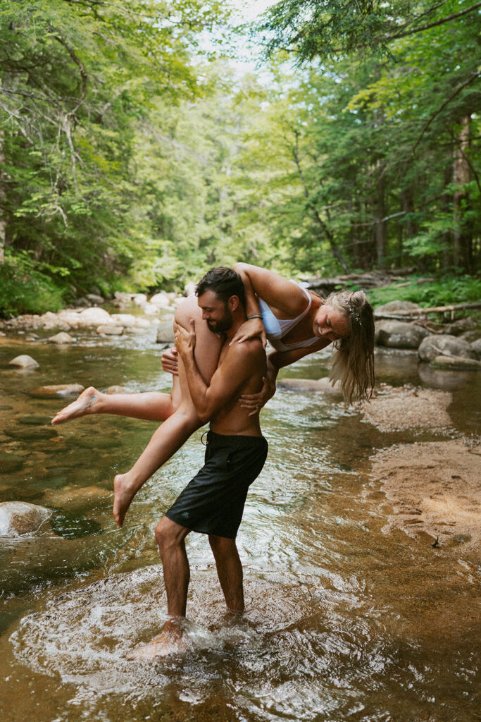 Couple playing in a mountain creek during their White Mountains adventure elopement.