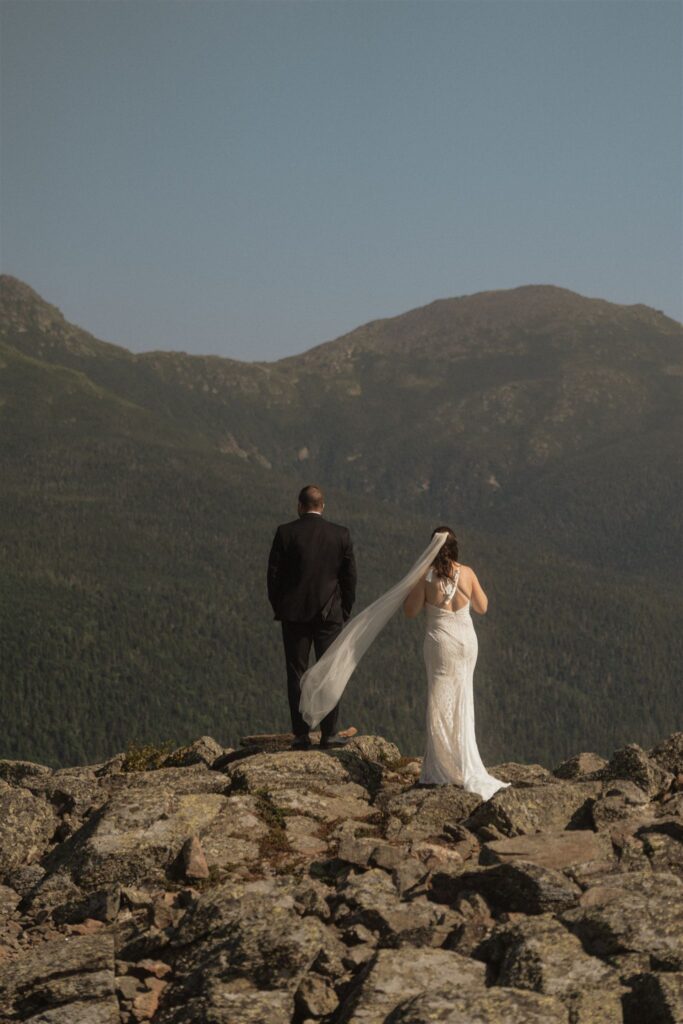 Couple walking along a mountain ridge during their White Mountains elopement
