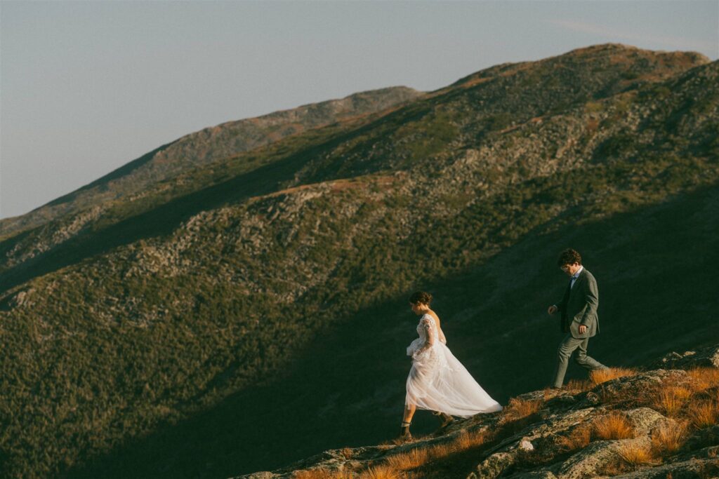 Couple hiking along a mountain ridge during a White Mountains elopement