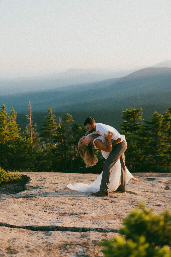 Couple celebrating on a mountain summit during a White Mountains elopement in New Hampshire