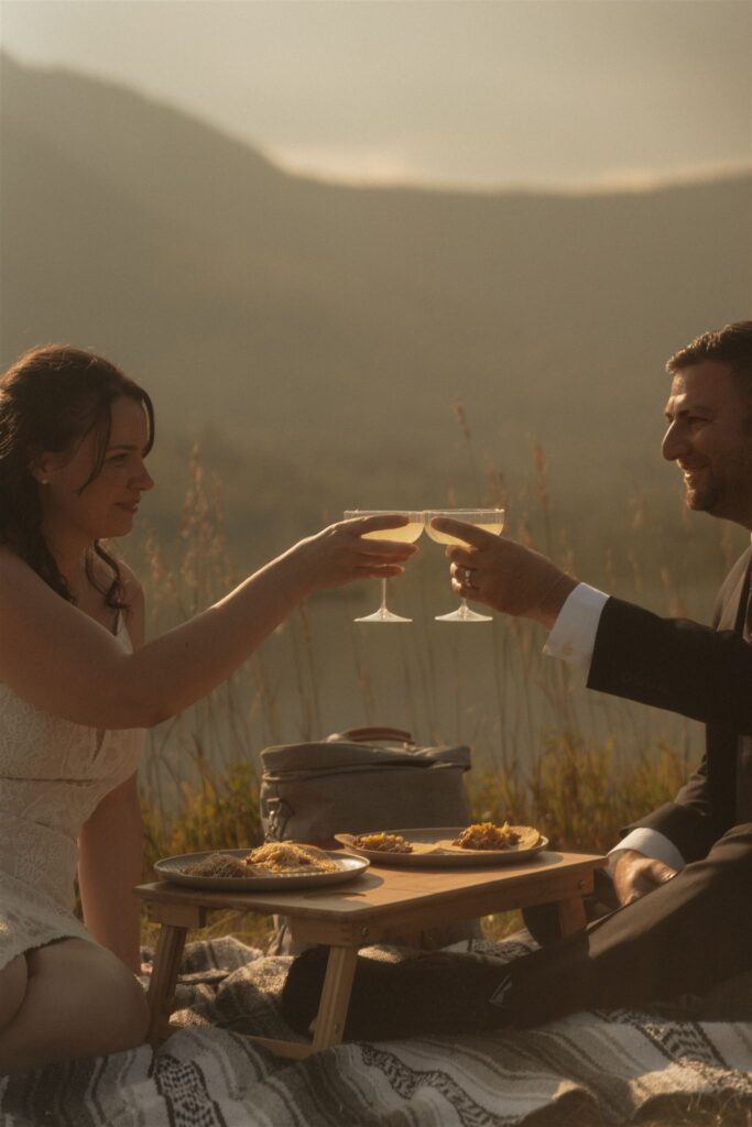 Couple celebrating their elopement with a sunset picnic in the White Mountains.